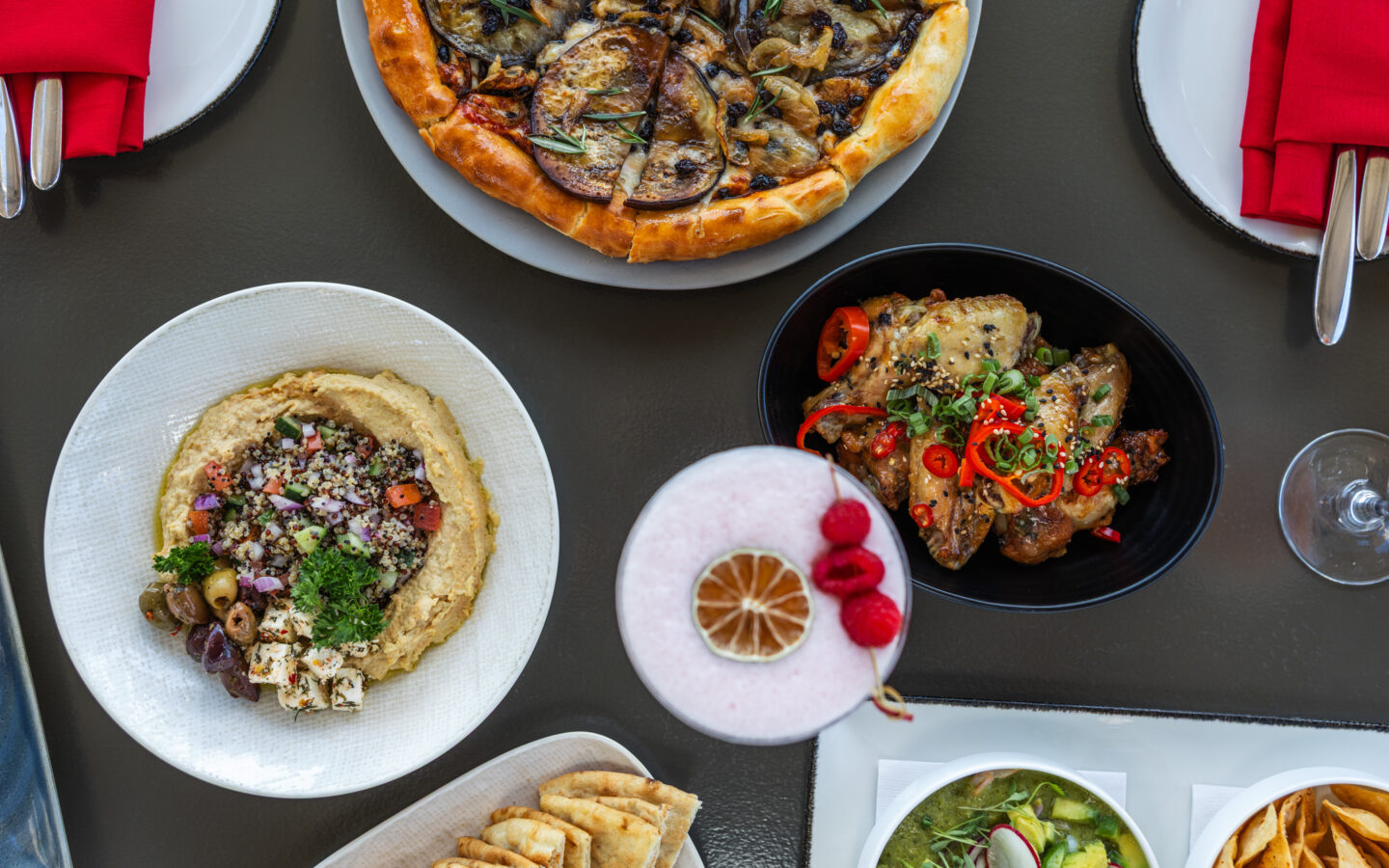a table topped with plates of food and drinks